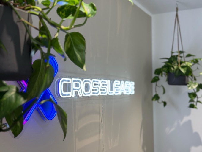 CrossLease Büro — Neon-Logo mit Pflanzen